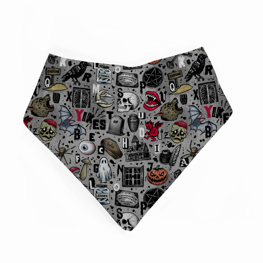 Halloween-themed bandana bib with various spooky designs on a white background