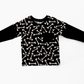 Black long-sleeve shirt with white bone pattern. Black pocket, black neckband. Handmade by My Spooky baby.