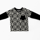 Black and white layered t-shirt. Main print is a checkerboard with skulls on it.  Long sleeves are black.