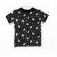 Black t-shirt with white ghosts, moons and stars pattern on a white background