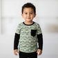 Child wearing a green shirt with bunny pattern against a white background