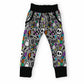 Gray kids' jogger pants with a colorful Halloween pattern of skulls, ghosts, and lightning bolts, featuring black ribbed cuffs and waistband.
