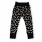 Goth kid joggers, black with white bone pattern.