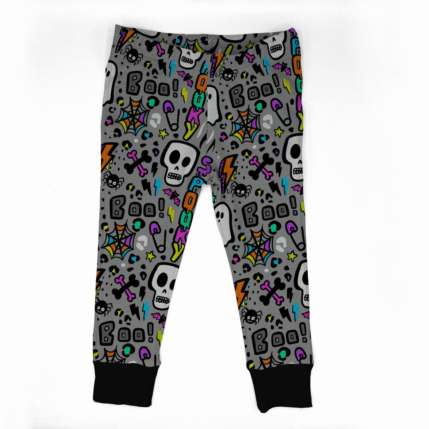 Gray children's jogger pants with a colorful Halloween pattern featuring skulls, ghosts, spiders, and 'Boo!' text, finished with black ribbed cuffs.
