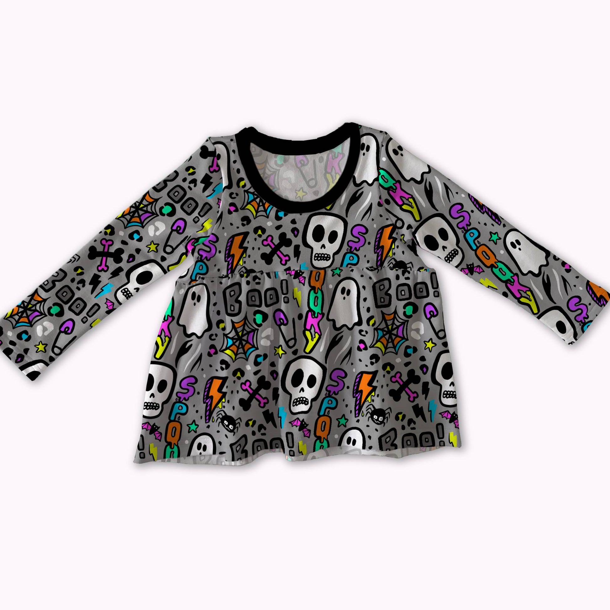 A long-sleeve baby/toddler top with a gray base covered in a colorful Halloween pattern of skulls, ghosts, lightning bolts, and tombstones, featuring a black crew neck.