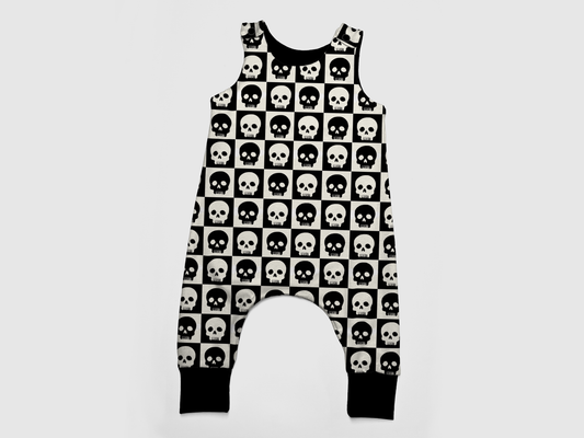 Black and White baby romper with checkers and skulls on it. Black cuffs. Handmade by My Spooky Baby.