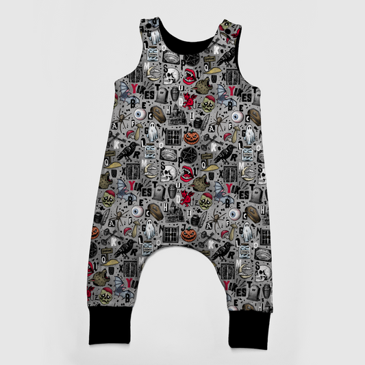 Spooky Baby romper, available up to 3T, grey background with Halloween designs on it : pumpkins, ghosts, spiderwebs, coffins, bats
Black cuff at legs. 