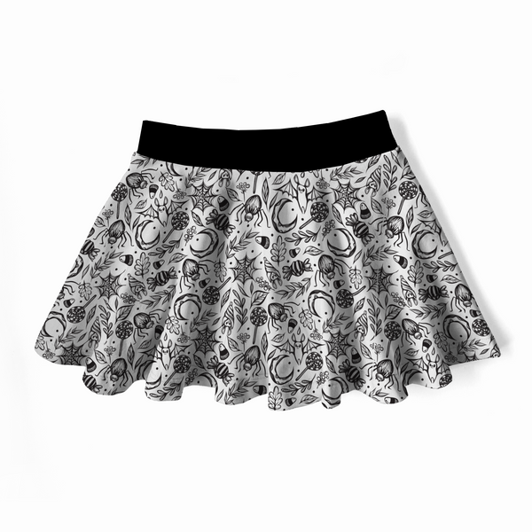 Goth twirly skirt, black waistband, white skirt with spooky cute designs on it : moons, spiders, bats, leaves, spiderwebs, candies. 