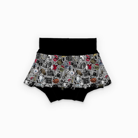 Black skirted bummies with a grey skirt featuring halloween designs. 